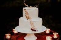 05 a white celestial wedding cake decorated with gold leaf and half moons with stars is a very elegant and chic idea for a neutral celestial wedding