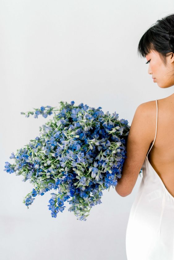 a bold blue delphinium wedding bouquet is a fantastic idea for a minimalist bride who wants to pull off some color