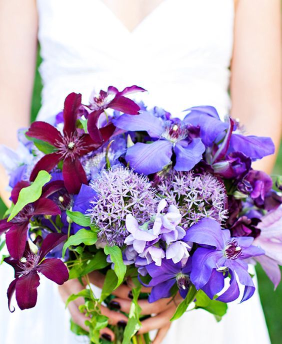 a bright wedding bouquet with violet, burgundy and lilac blooms including allium and greenery is a fantastic idea