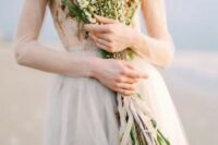 09 a coastal bride rocking a long stemmed wedding bouquet with small blooms is a very delicate and chic idea to rock