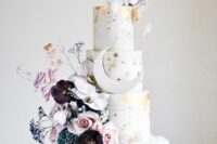 09 a white wedding cake with gold stars and gold leaf, constellations, a half moon, with dark and pastel blooms and cotton on top