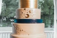 11 a white, navy and gold celestial wedding cake with stars, pearls, moons and some lettering is a gorgeous idea for a celestial wedding