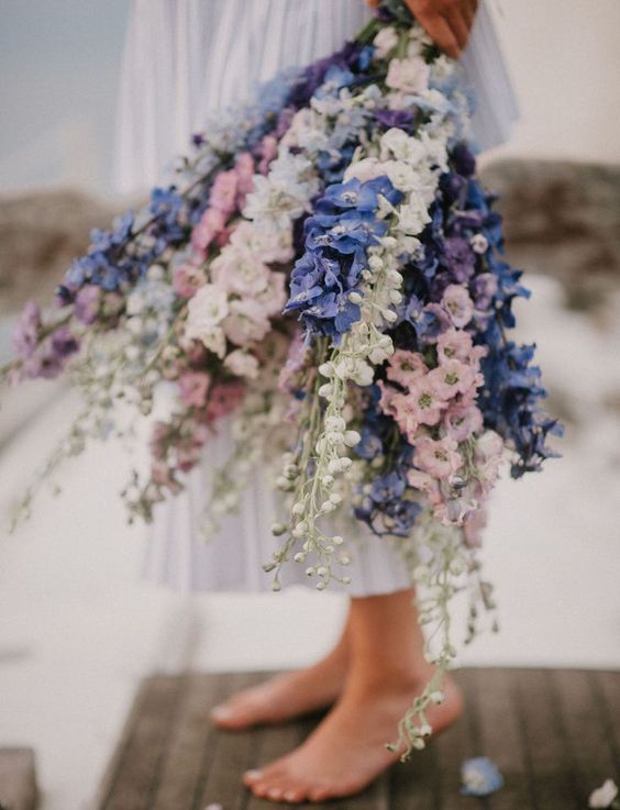 a fantastic long stem wedding bouquet composed of pink, white and blue delphinium is a lovely solution to make a statement