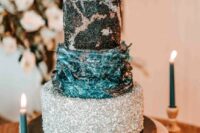 14 a celestial wedding cake with a silver tier, a navy textural one, a black tier with silver decor and a silver sphere on top