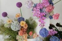 14 colorful modern wedding florals – pink orchids, allium, various hydrangeas and greenery in laconic square vases