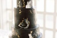 16 a black celestial wedding cake with gold details, moons, stars and large crystals is a great idea for a celestial wedding