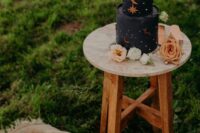 a stylish moody black wedding cake