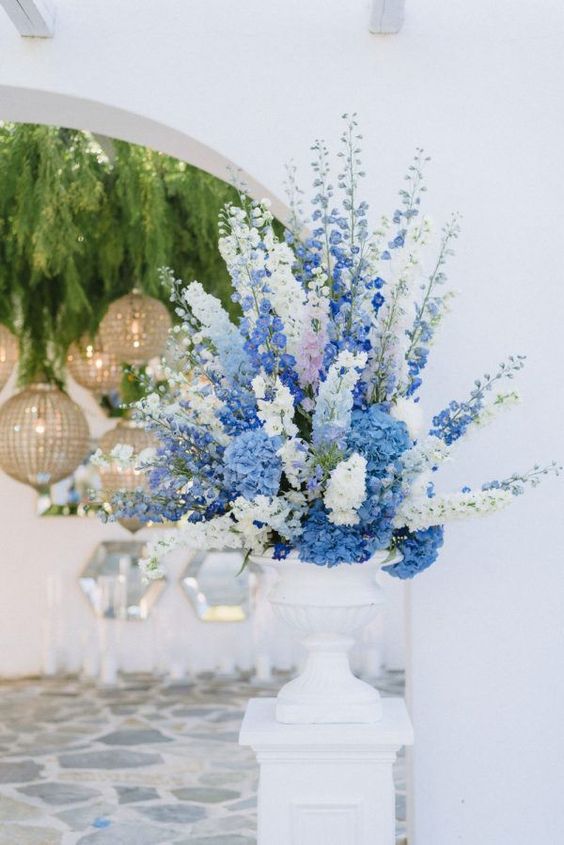 a bold floral arrangement of blush, blue and white delphinium in a large white vase is a fantastic idea for a coastal bride