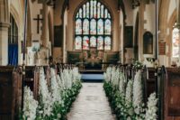 21 a church wedding aisle lined up with white delphinium and greenery is a gorgeous idea for a spring wedding