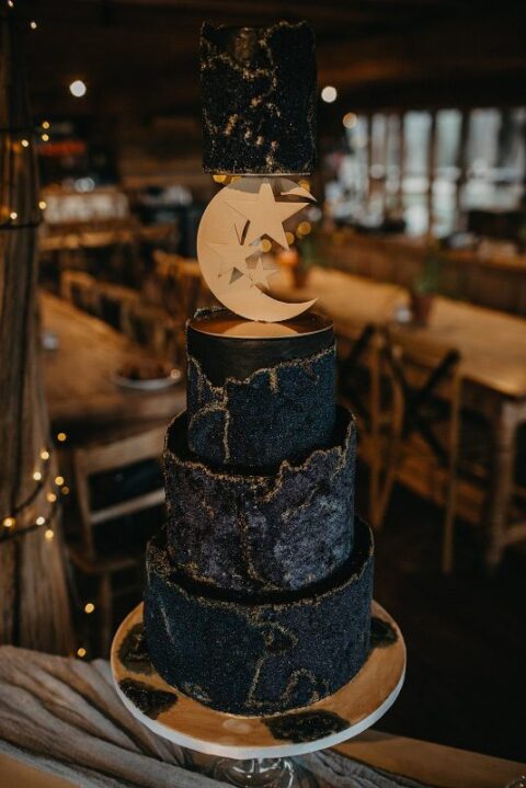 a dark celestial wedding cake done in midnight blue and gold, with glitter touches, a half moon and stars is wow for a themed wedding