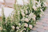 27 a sophisticated wedding aisle with greenery, creamy and blush roses, greenery and white delphinium is amazing
