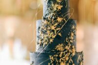 31 a midnight blue wedding cake decorated with gold leaf, with gold stars and sparkles, with a bit of gold swirls is wow