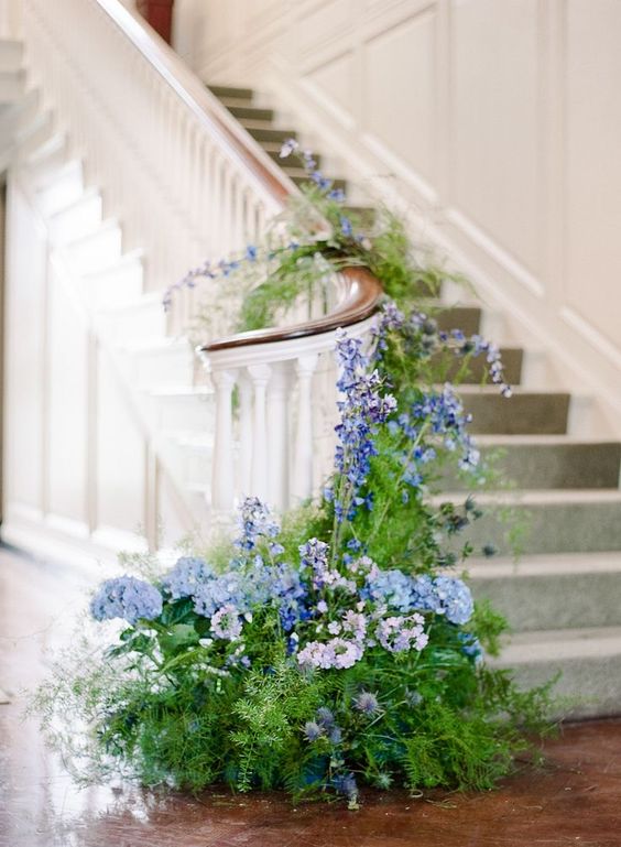 beautiful wedding staircase decor with greenery and thistles, lilac and blue blooms including delphinium is amazing