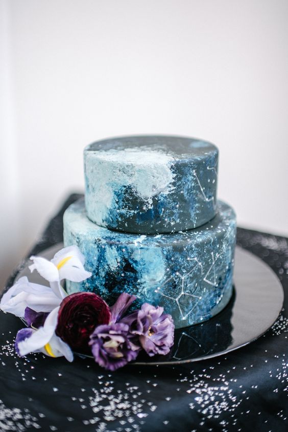 a navy galaxy wedding cake with constellations and a bit of light blue detailing to imitate night sky