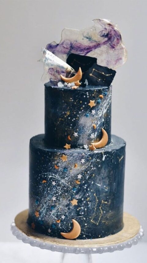 a navy starry night wedding cake with little stars and moons, a purple swirl and some chocolate shards on top is a lovely idea
