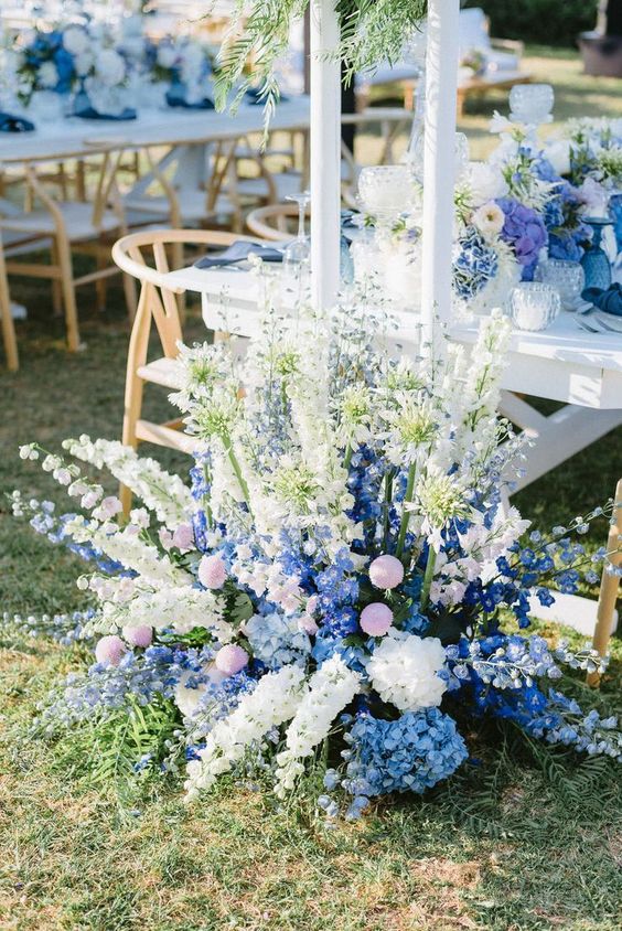 gorgeous floral wedding decor done with white and blue delphinium and pink flowers is a fantastic idea for a pastel-infused wedding