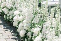 37 stunning wedding aisle decor done with white roses, greenery and white delphinium is a beautiful and chic idea