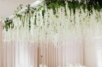 41 a neutral wedding reception with delphinium overhead installations pumped up with lights hanging down