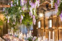 44 greenery, white and lilac delphinium hanging over the reception table and ones placed on the table make the space magical