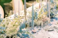 49 stylish pastel wedding table decor with blue and white delphinium, blue and blush candles and greenery and neutral porcelain