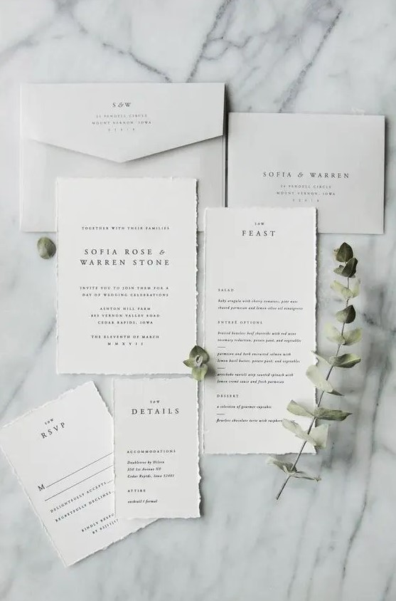 a clean minimalist wedding invitation suite with a raw edge and elegant envelopes is a gorgeous idea for a minimal wedding
