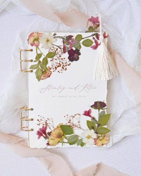 a fantastic pressed flower wedding guest book with gold touches is a very sophisticated idea