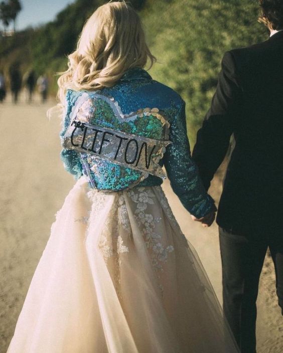 a blue sequin bridal jacket with a sequin heart and a new second name is a fantastic solution for a bride for her 'something blue'