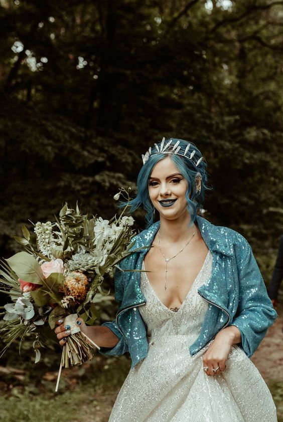 a blue sequin moto bridal jacket perfectly matches the color of the bridal hair and lips is a fantastic solution