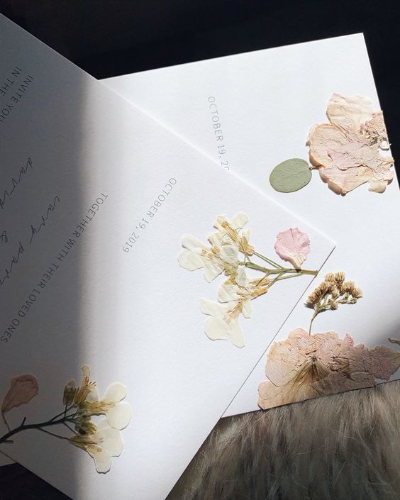 a gorgeous pressed flower wedding invitation with delicate printing and calligraphy is a lovely idea for a summer wedding