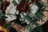 07 a lush winter wedding bouquet with red and blush blooms, thistles, vine, ferns and berries