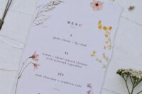 08 a gorgeous pressed flower wedding menu is a stylish idea for a spring or summer boho wedding