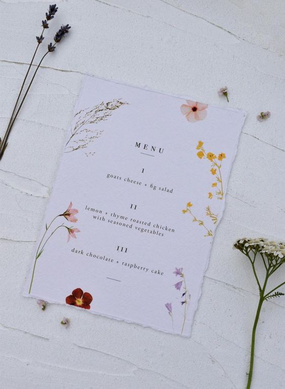 a gorgeous pressed flower wedding menu is a stylish idea for a spring or summer boho wedding