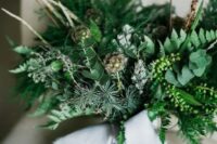08 a lovely and textural wedding bouquet of greenery and evergreens, twigs and berries, seed pods and grey ribbon