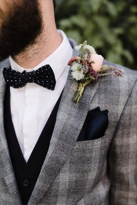 a grey plaid pantsuit with a black waistcoat, a white shirt, a black polka dot bow tie and a black handkerchief are a super stylish combo