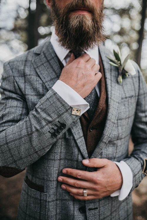 a grey plaid pantsuit, a brown waistcoat, a white shirt and a grey tie, a white boutonniere for a stylish fall or winter look