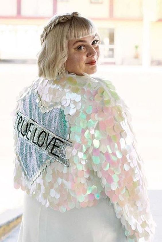 a jaw-dropping holographic sequin bridal jacket with a sequin heart and some letters is a lovely idea for a colorful wedding