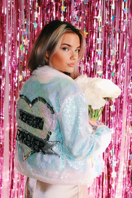 a light blue sequin bridal jacket with a heart and some letters is a pretty and glam addition to the look