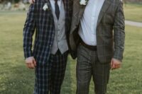 12 a groom and groomsman wearing plaid and windowpane print suits, white shirts and white floral boutonnieres look cool