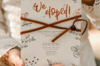 14 a cool boho elopement announcement with fun calligraphy, botanical prints and leather cord on it
