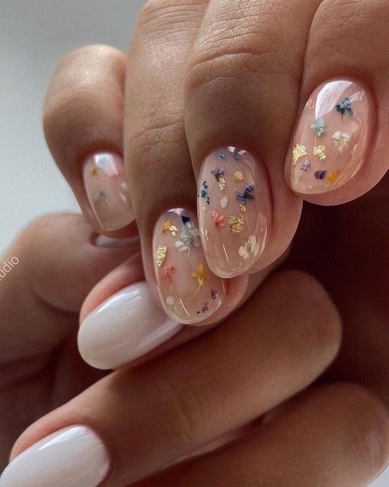 milky and nude wedding nails with dried blooms and gold foil are amazing for a spring or summer boho bride