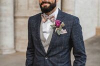 16 a navy plaid pantsuit, a light grey waistcoat, a white shirt, a bold floral bow tie and a pink boutonniere are an elegant combo