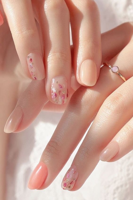 nude and coral nails and accented nails with white and pink floral patterns are amazing for a spring or summer wedding