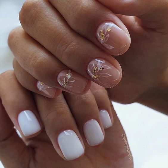 white and nude nails, botanical patterns and gold foil make the nail look chic and very feminine