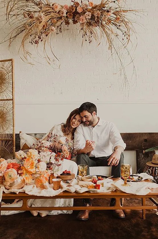 a cool boho post elopement party at home, with beautiful blooms and stylish decor is a lovely idea to celebrate your tying the knot