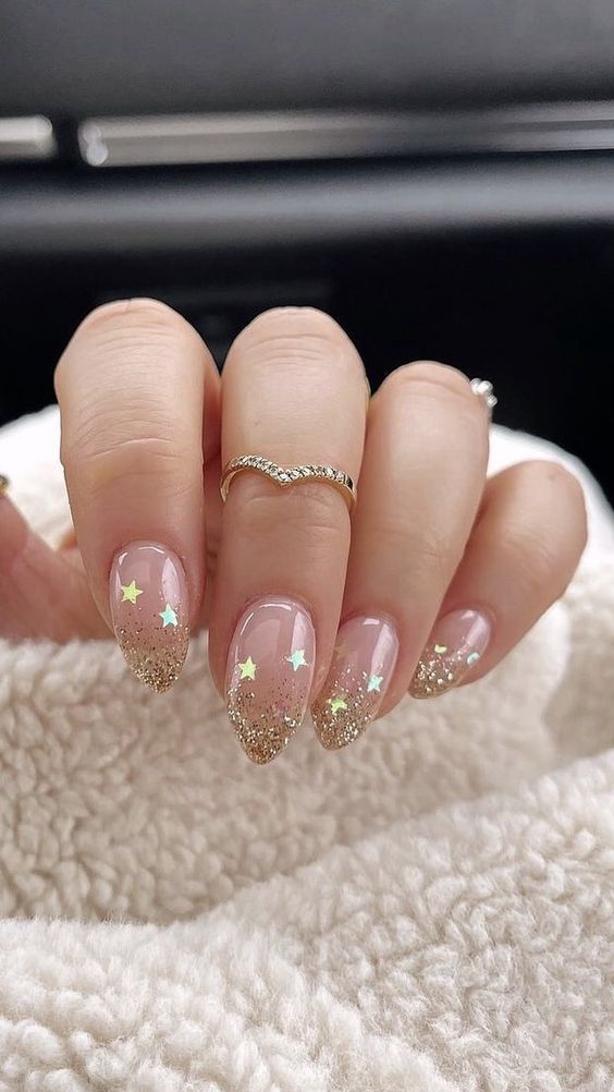 a nude bridal manicure with gold glitter tips and gold stars is an amazing idea for any bride