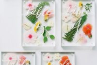25 super cool and bright pressed flower and leaf wedding table numbers with white calligraphy are gorgeous