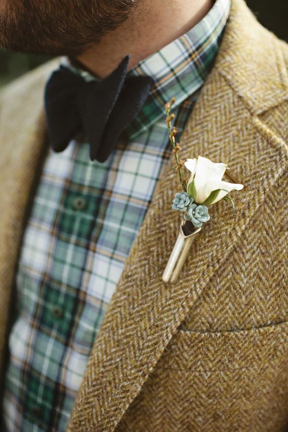 a green plaid shirt, a black bow tie, a beige tweed blazer and a white boutonniere for a relaxed and cozy groom's look
