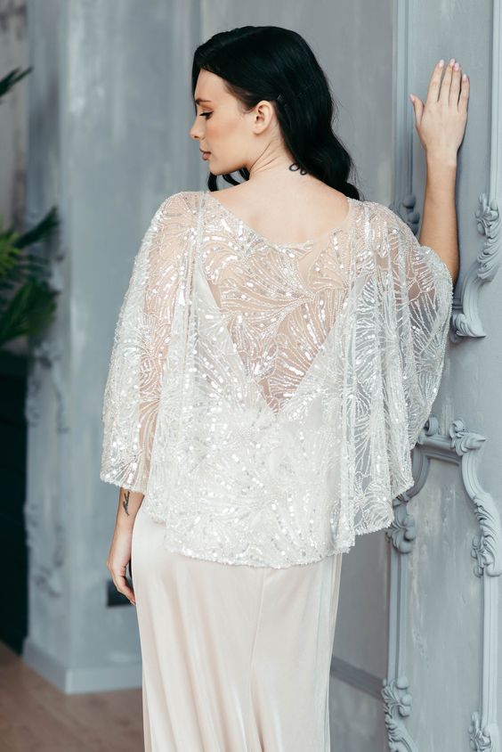 a delicate embellished bridal capelet with a cutout back is a fantastic solution for a holiday or just glam bride