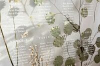 29 a fantastic organic seating chart with leaves and blooming branches plus white letters is a chic and stylish idea for a modern wedding