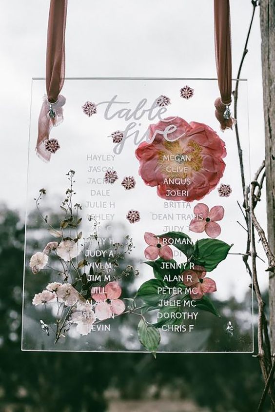 a fantastic pressed flower wedding escort card with pink and blush blooms and leaves is a gorgeous solution for a garden wedding